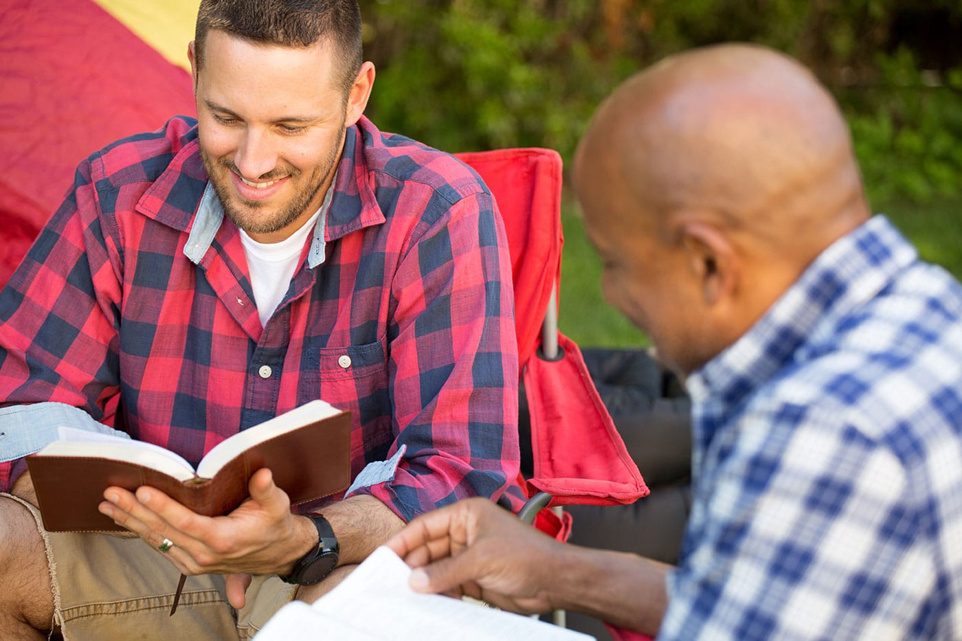 Two men having a Bible study outside