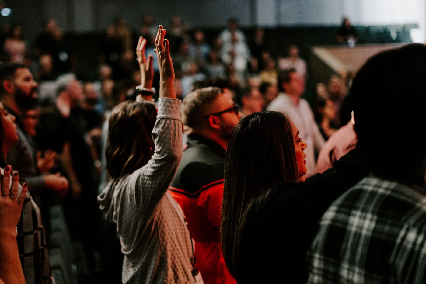 Woman with hands up during worship service